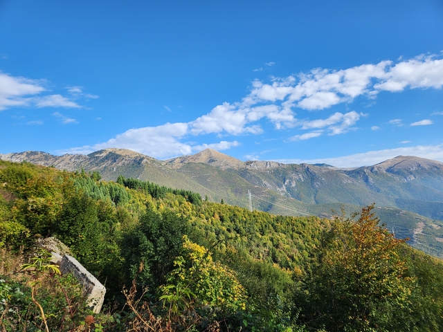 Mountainous landscape with a clear blue sky.