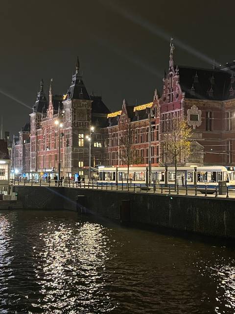 Historic building by the water at night.
