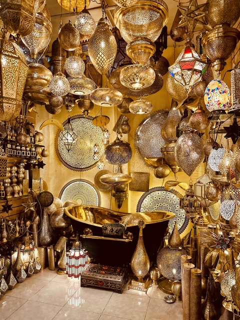 Shop filled with ornate metal lanterns and decorations.