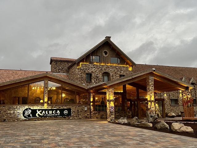 A stone building with a sign and wooden architecture.