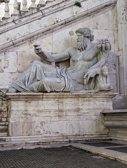 Statue of a reclining figure and Sphinx.