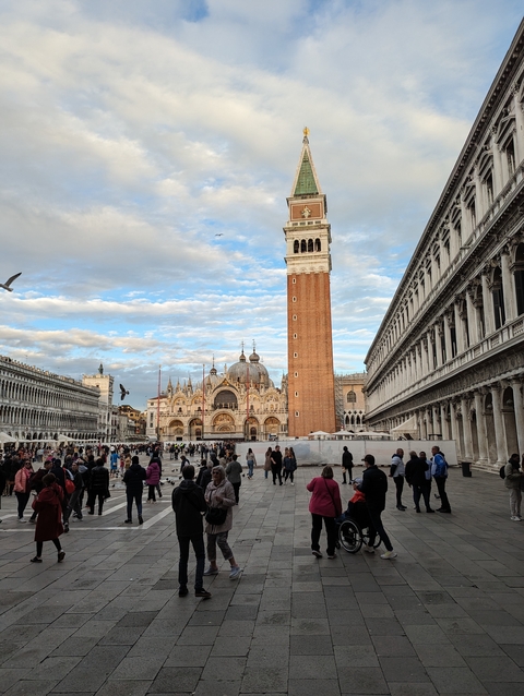 St. Mark's Square crowded with tourists, view of the basilica and bell tower.