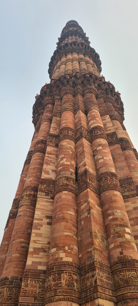 Detailed view of intricate carvings on Qutub Minar.