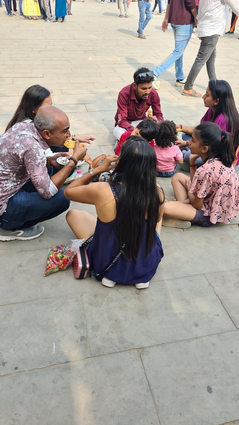 People enjoying a meal on the street.