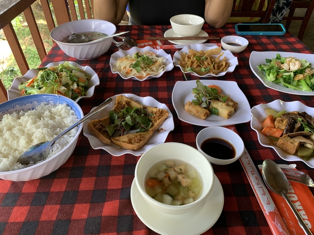 Table set with multiple Vietnamese dishes.