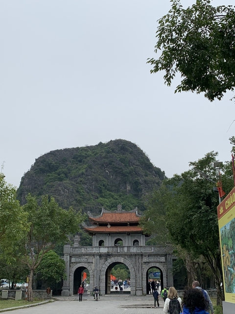 Mountainous landscape with rooftops visible.
