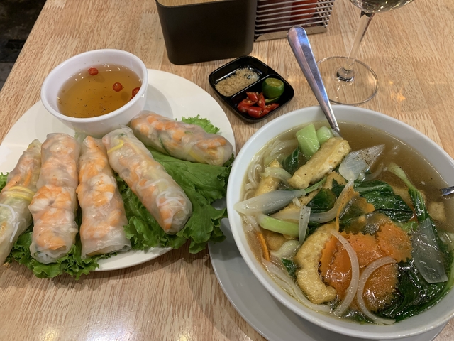 Vietnamese meal with pho and spring rolls.