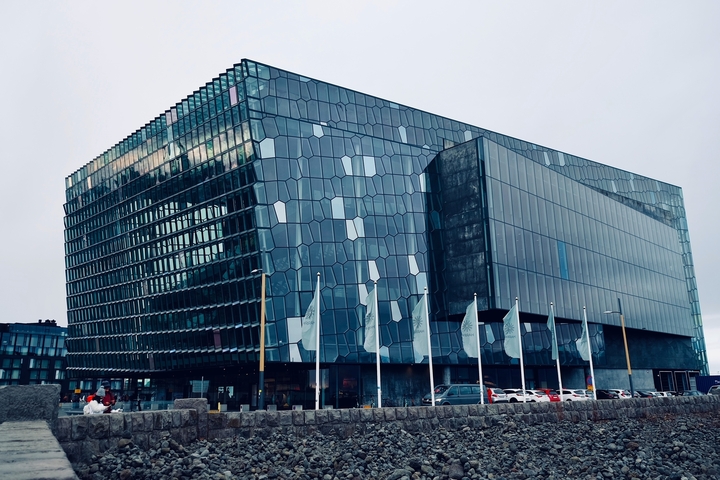 Contemporary glass building with geometric patterns.