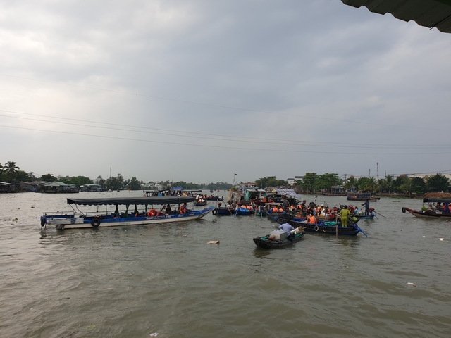 Crowded boats at a floating market on a river.