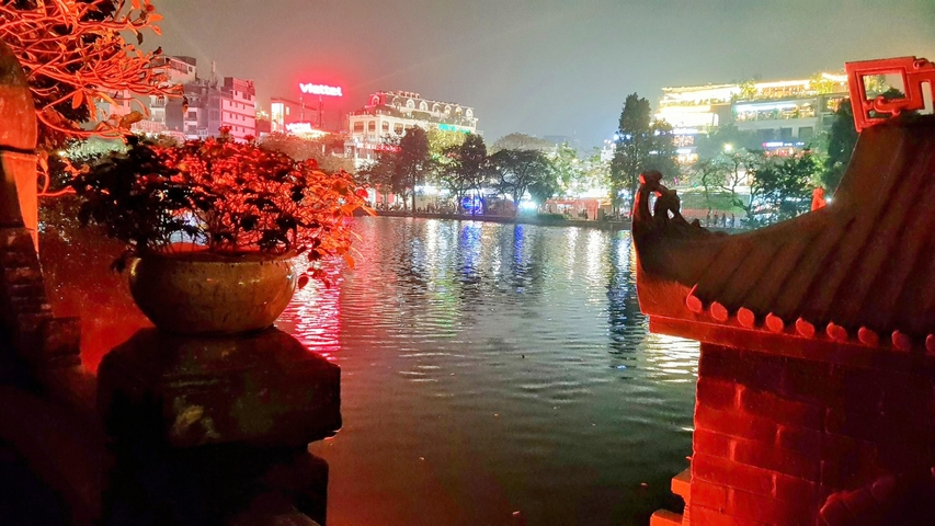 Lake with a city backdrop brightly lit at night