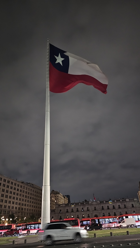 Flagpole with a waving flag against the sky