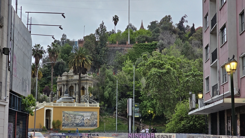 Urban cityscape with hills, trees, and historic architecture
