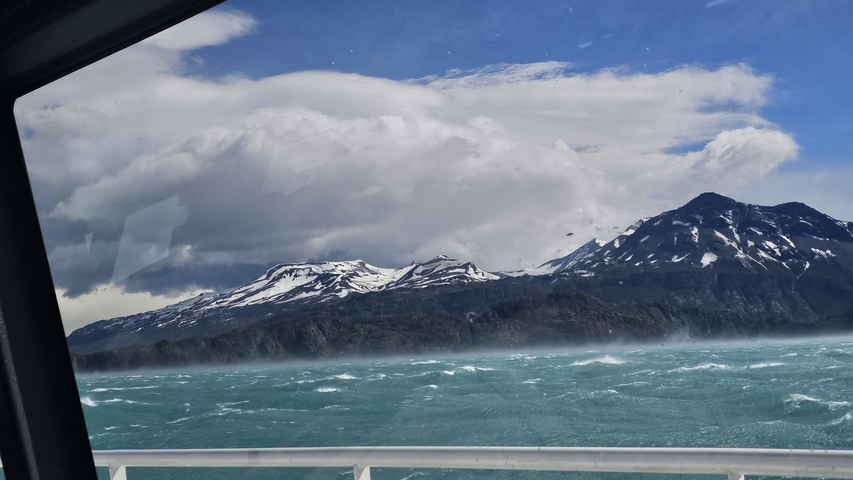 Snow-capped mountains and turbulent sea