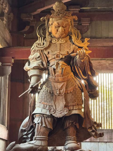 Close-up of a wooden warrior statue's armor.