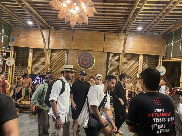 People participating in a cultural event with performers.