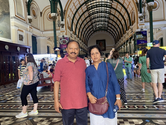 Couple posing inside a historic building.