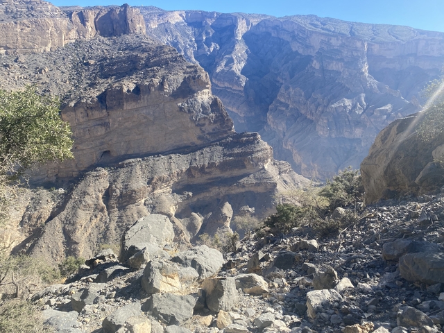 Imposing rocky canyon with sunlight casting deep shadows.