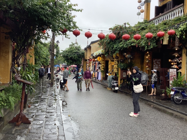 Street in Hoi An with red lanterns and shops.