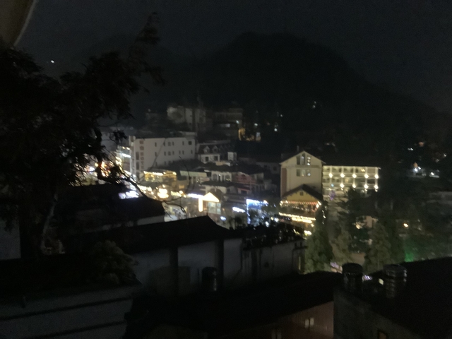 Blurry night view of a town with lights.