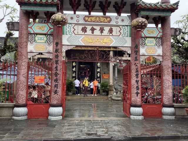 Ornate temple entrance with visitors taking photos.