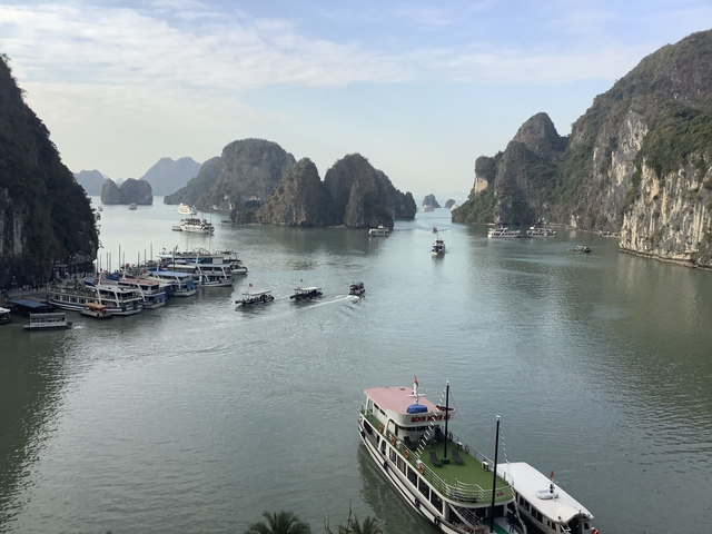 Boats navigating through the stunning karst landscape.