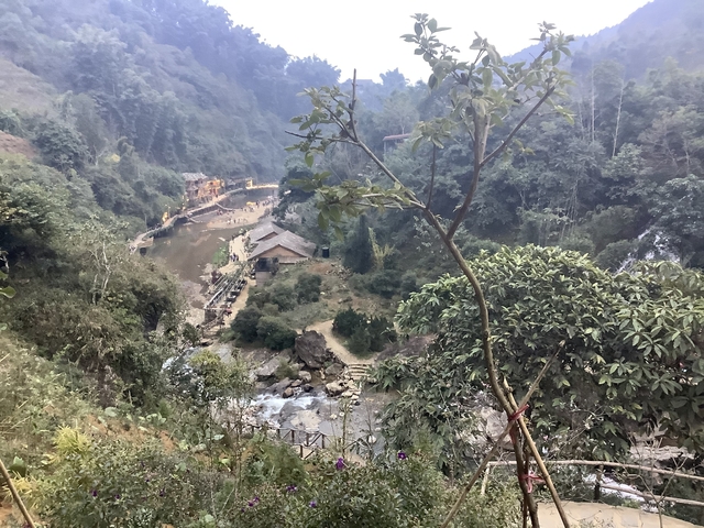 Scenic view over a mountainous village with a river.