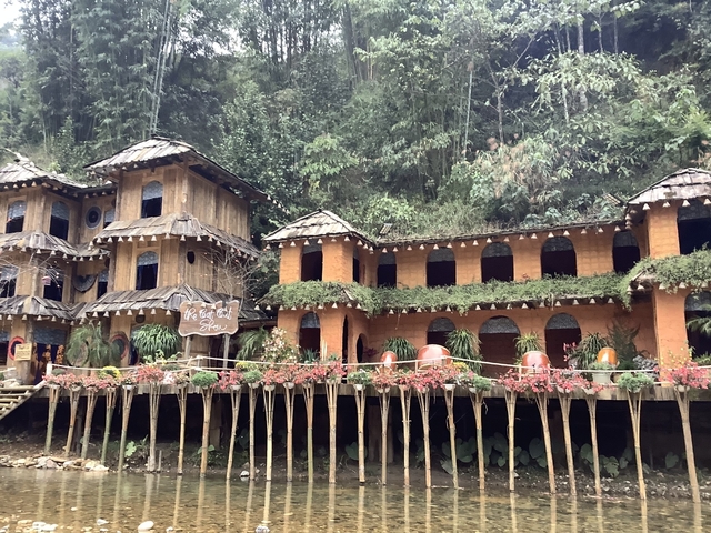 Decorative buildings amidst a forested area.