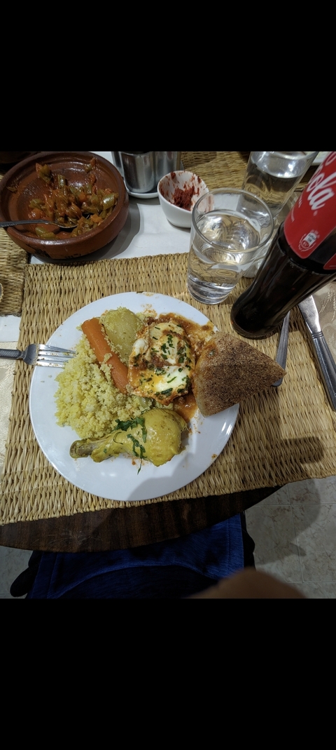 Plate of couscous with chicken and vegetables.