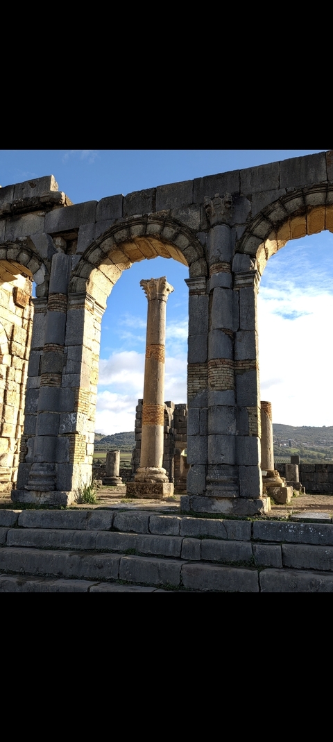 Ancient Roman-style ruins with arches and columns.