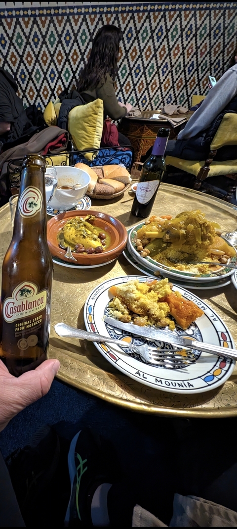 Traditional Moroccan dishes served on table with beer.