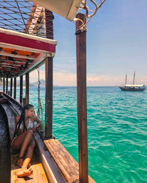 Person on a boat enjoying the blue ocean waters.