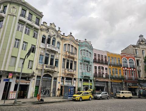 Historic row of colorful buildings on a cloudy day.
