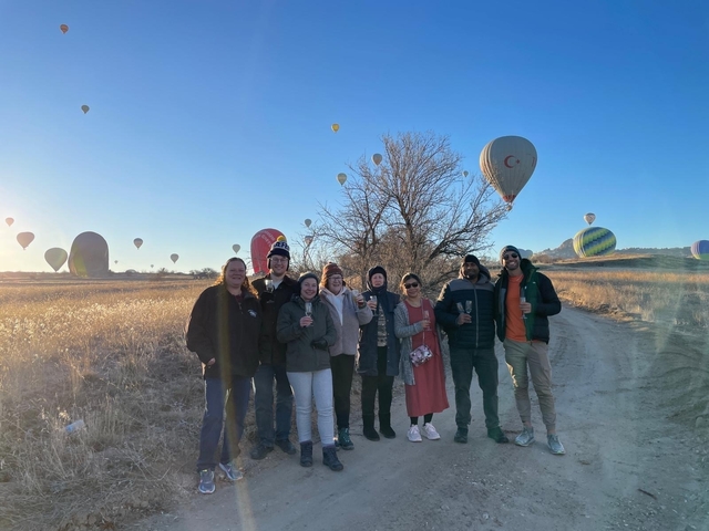 Group photo with many hot air balloons in the sky