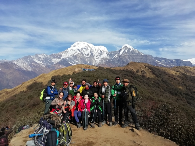 Group of hikers with mountains in the background.