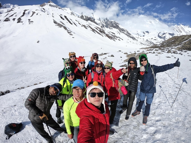 Group of people in the snow wearing colorful jackets.