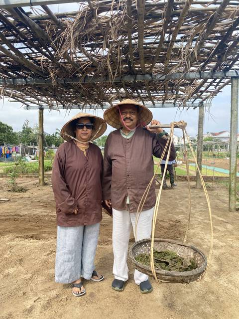 Couple posing in a rustic farming location.