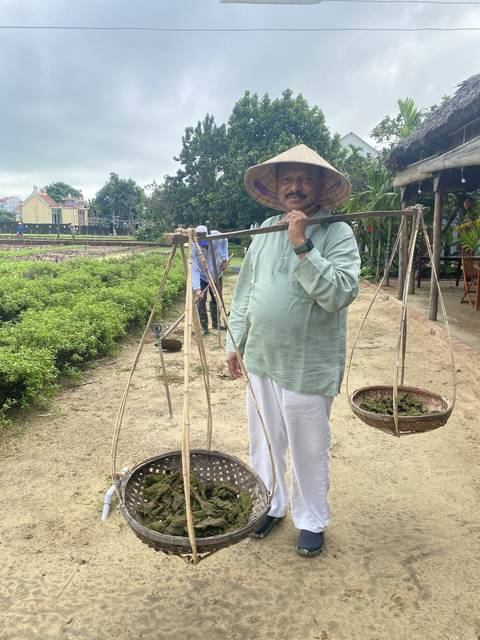 Man posing with a carrying pole.