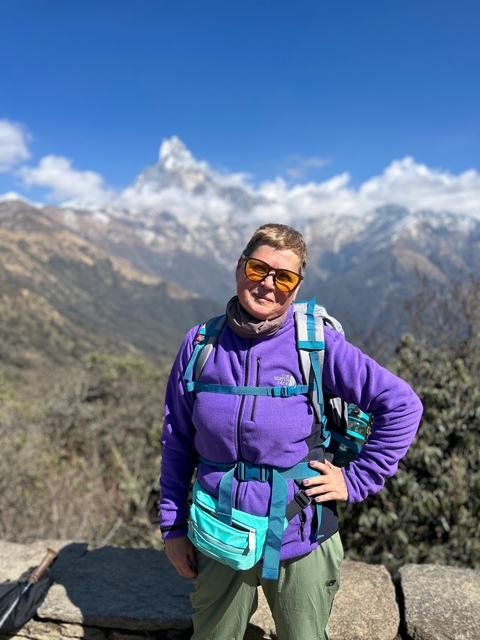 Hiker with snowy mountains in the background.