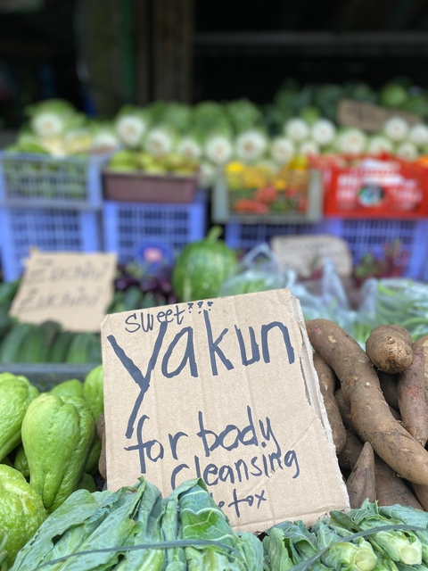 Vegetable market with handwritten labels.