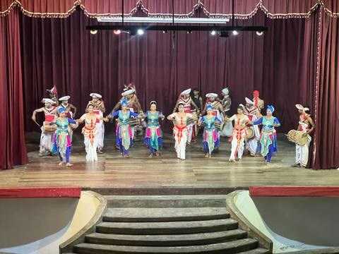 A performance with traditionally dressed dancers on a stage.