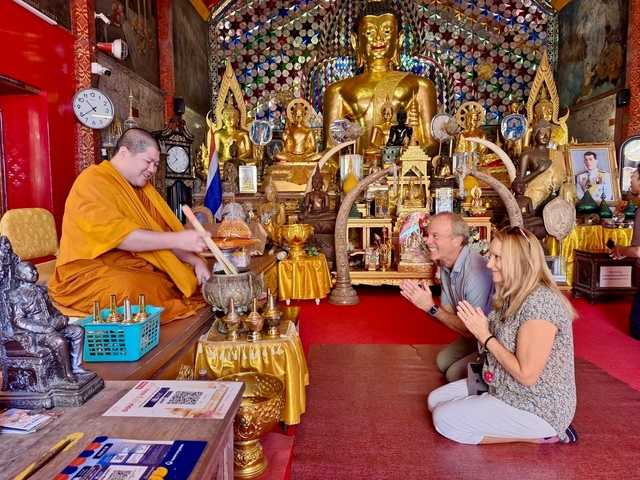 People receiving blessings in a temple.