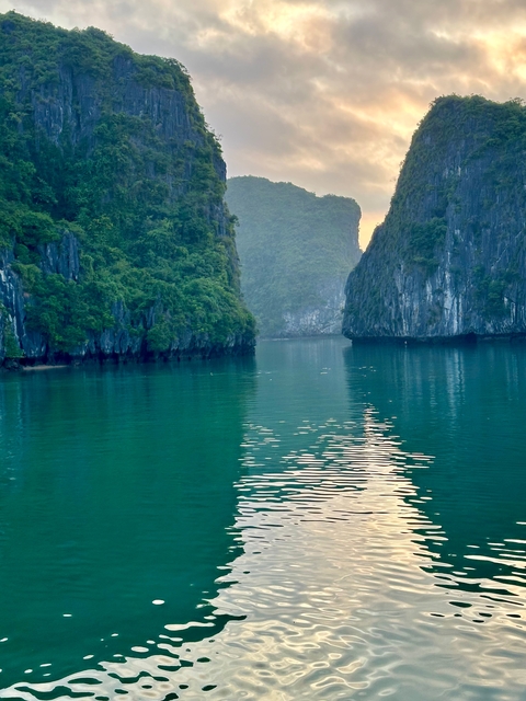 Serene view of water with rocky cliffs.