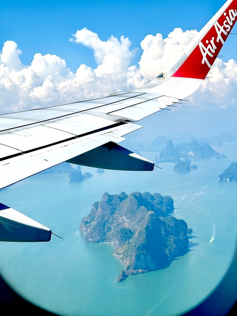Aerial view from an airplane over water with small islands.