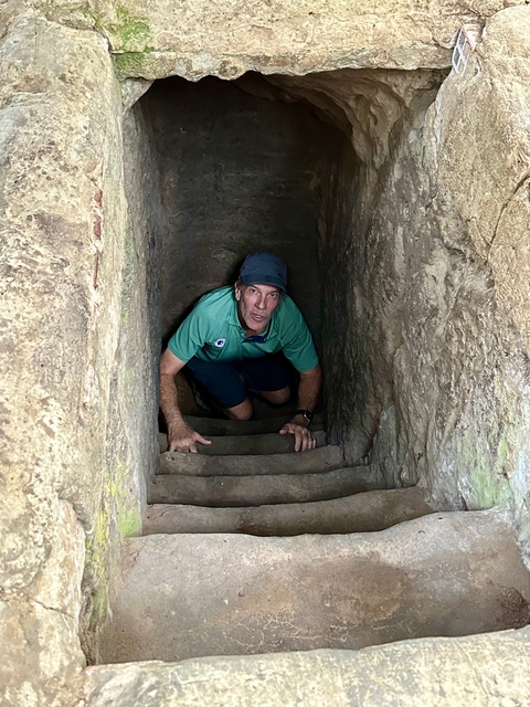 Person crawling through a narrow tunnel.