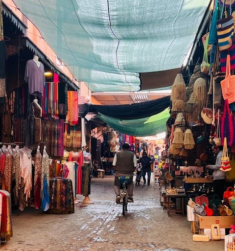 Market scene with a variety of textiles and decorations.