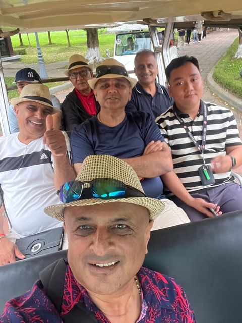 Group of people enjoying a ride, one giving thumbs up.