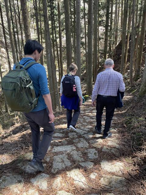 People hiking through a forest path.