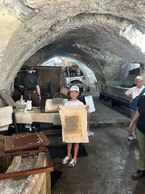 Child holding a sheet in an underground historic site.