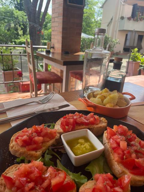 Table with tomato bruschetta and appetizers in a restaurant setting.