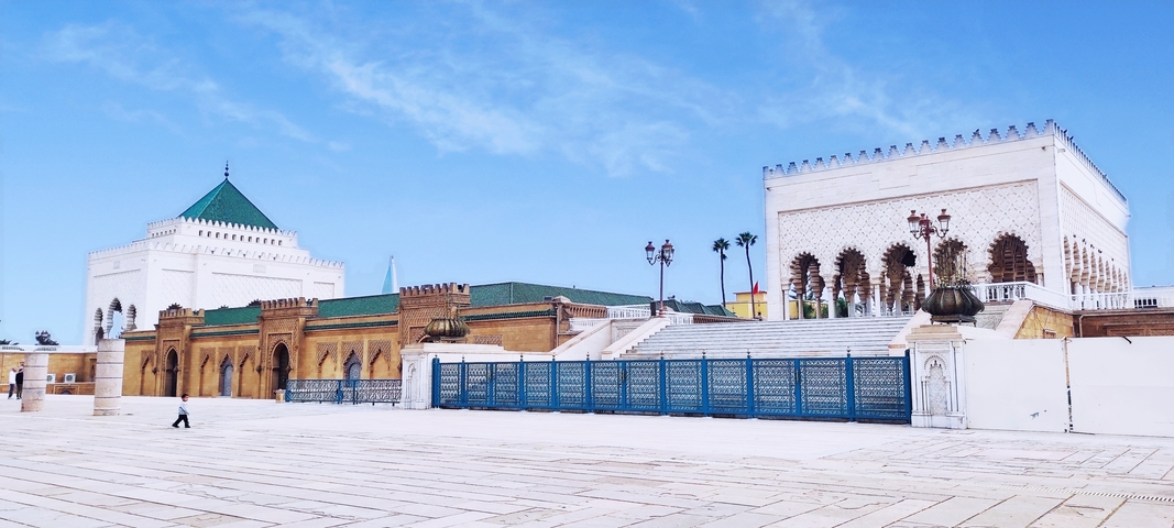 Architectural complex with grand buildings and ornate gates.